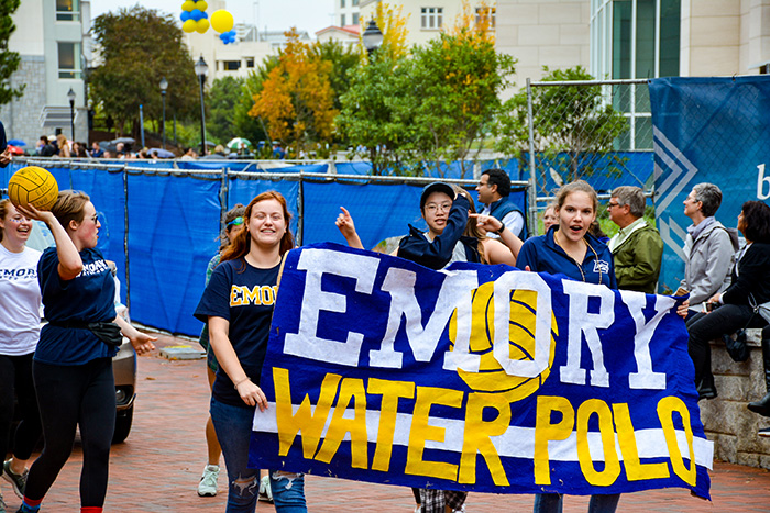 The Emory Water Polo team walks through the Homecoming parade